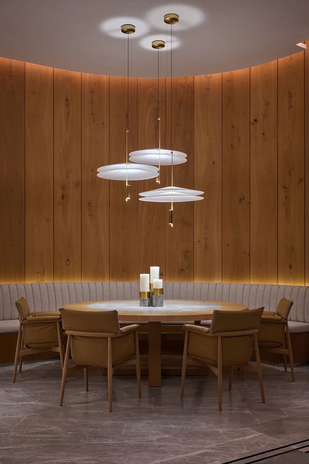 Curved wood planks wall defines the dining area