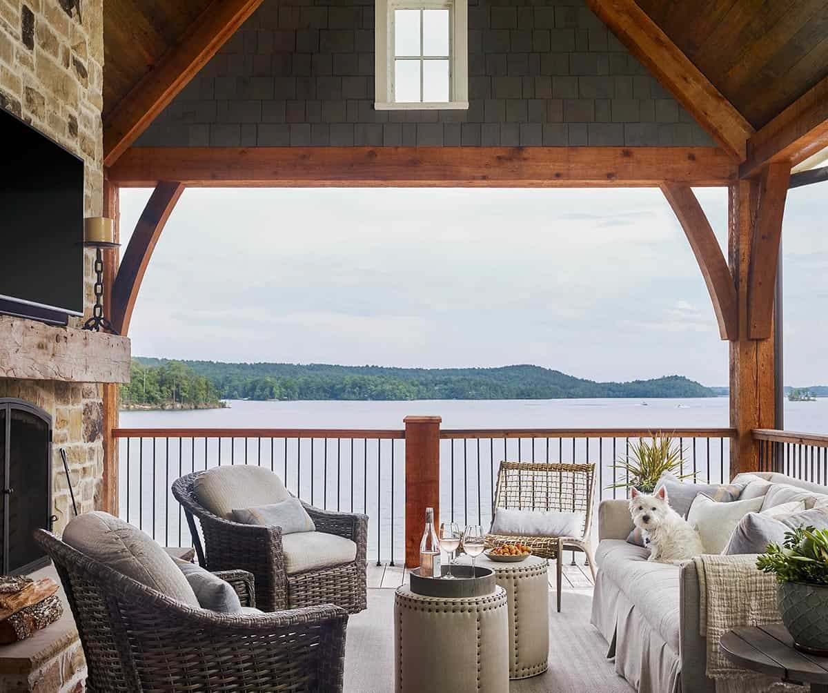 contemporary covered patio with outdoor furniture overlooking the lake