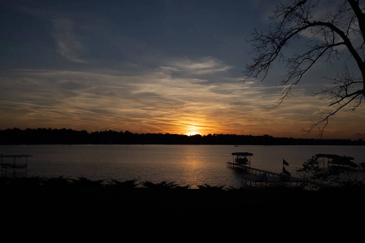 modern coastal style home lakeside view at sunset