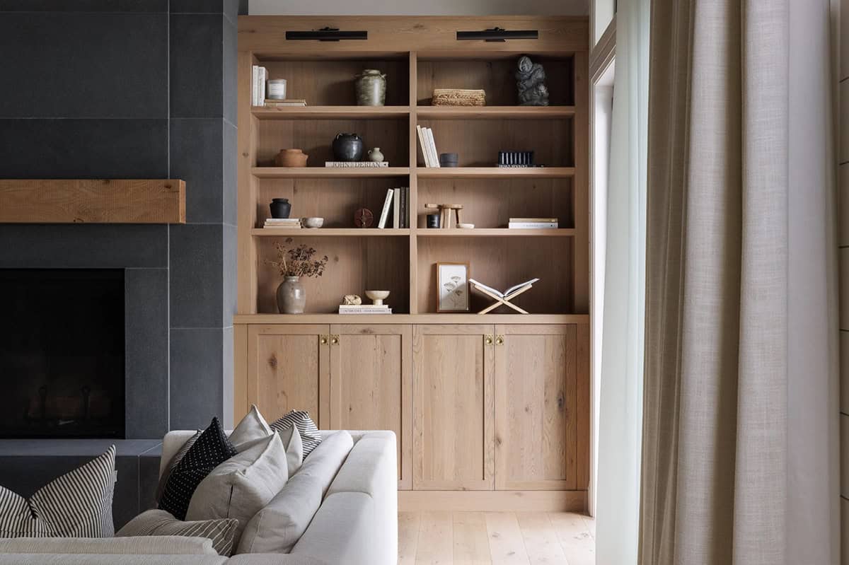 beach style living room with built-in display shelves