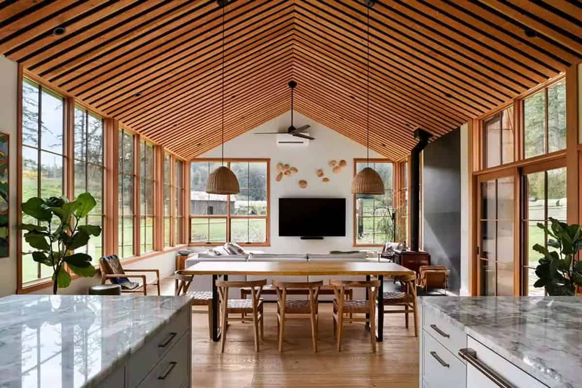 Interior view of a modern farmhouse with large windows and wooden accents on Orcas Island.