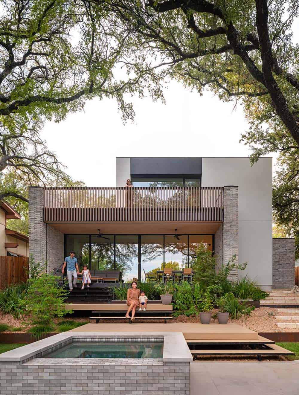 modern home exterior with a patio and hot tub