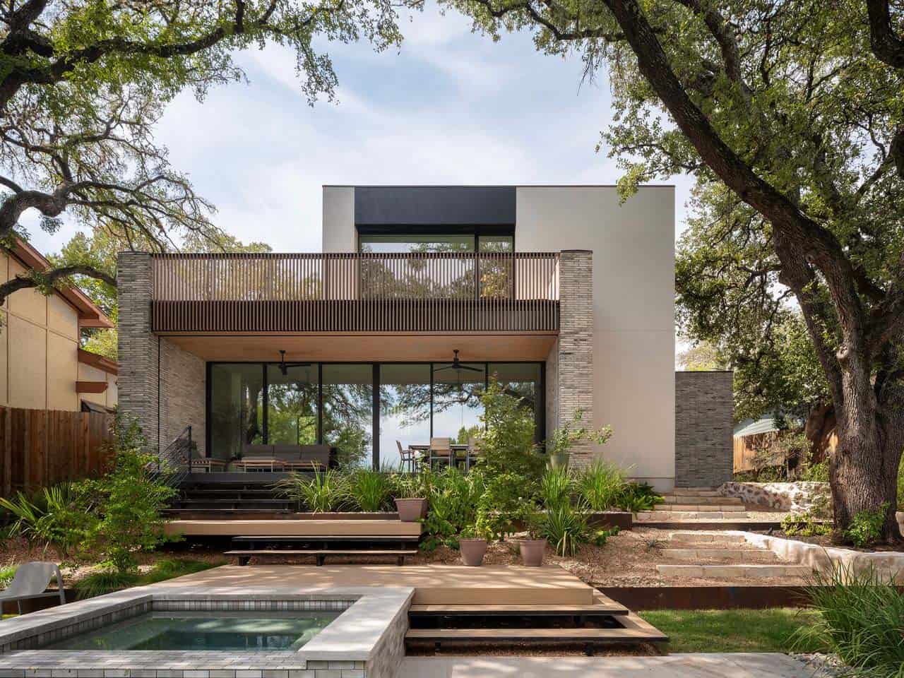 modern home exterior with a patio and hot tub