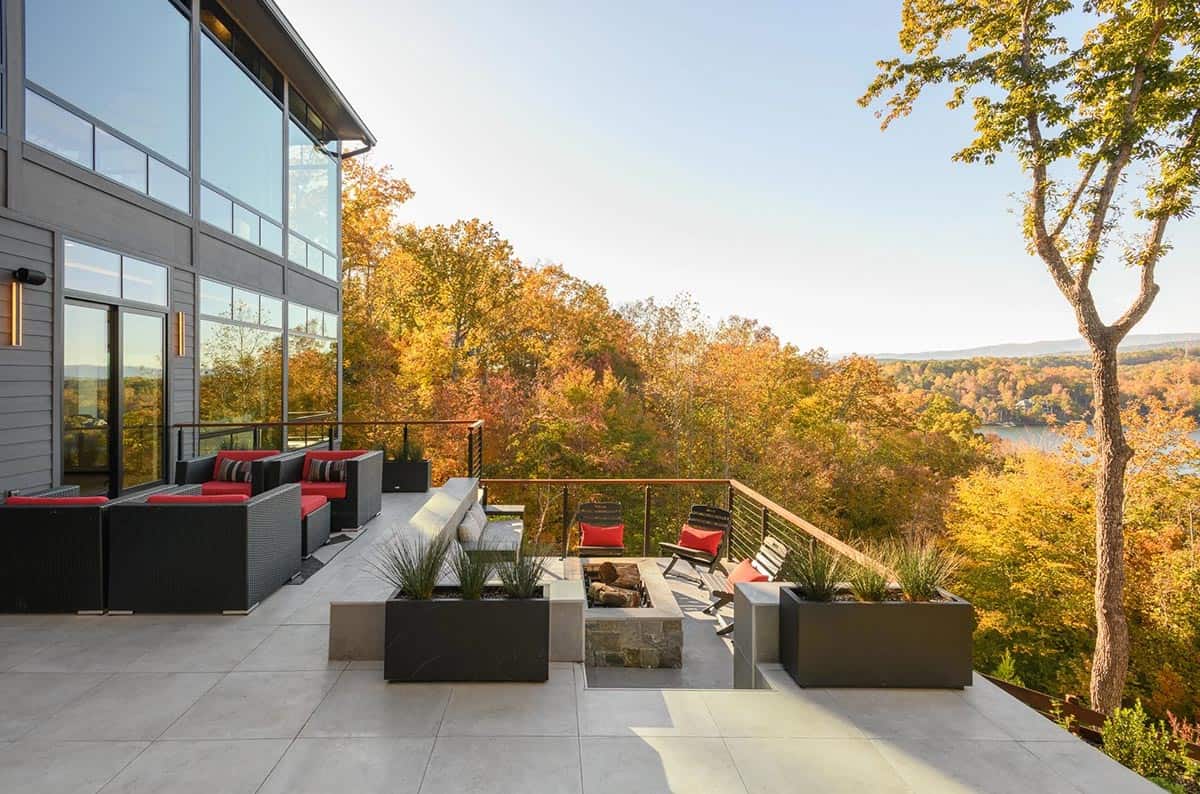 modern lake house backyard with a large patio and outdoor furniture