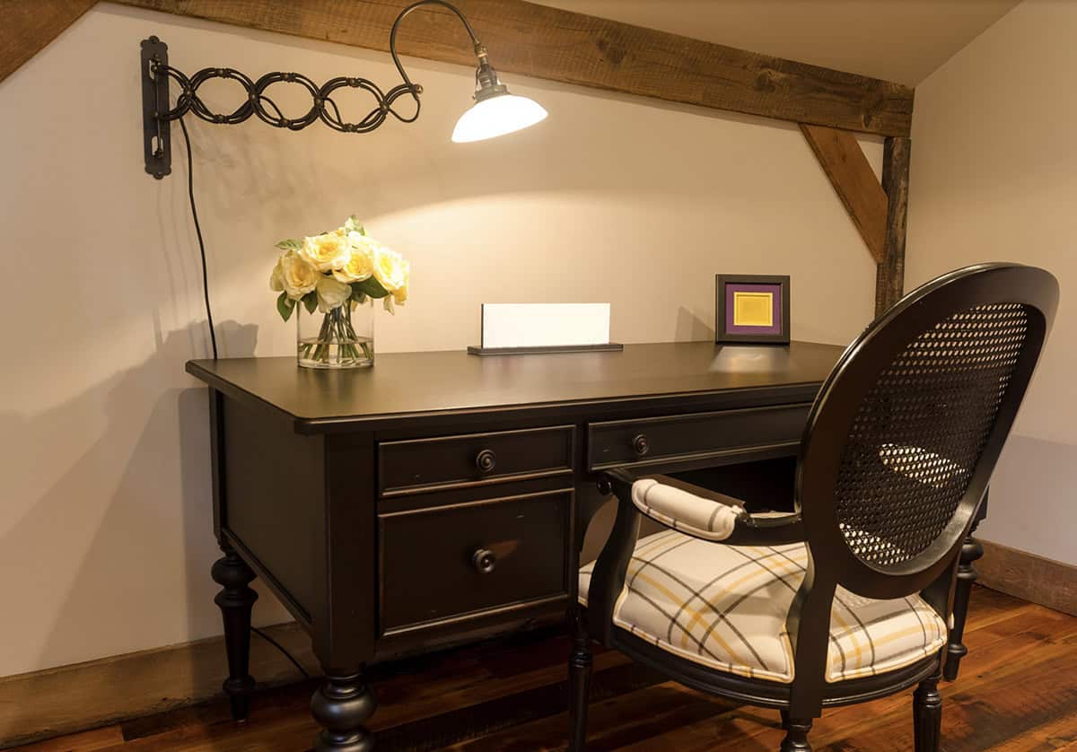 rustic guest room with a desk and and chair