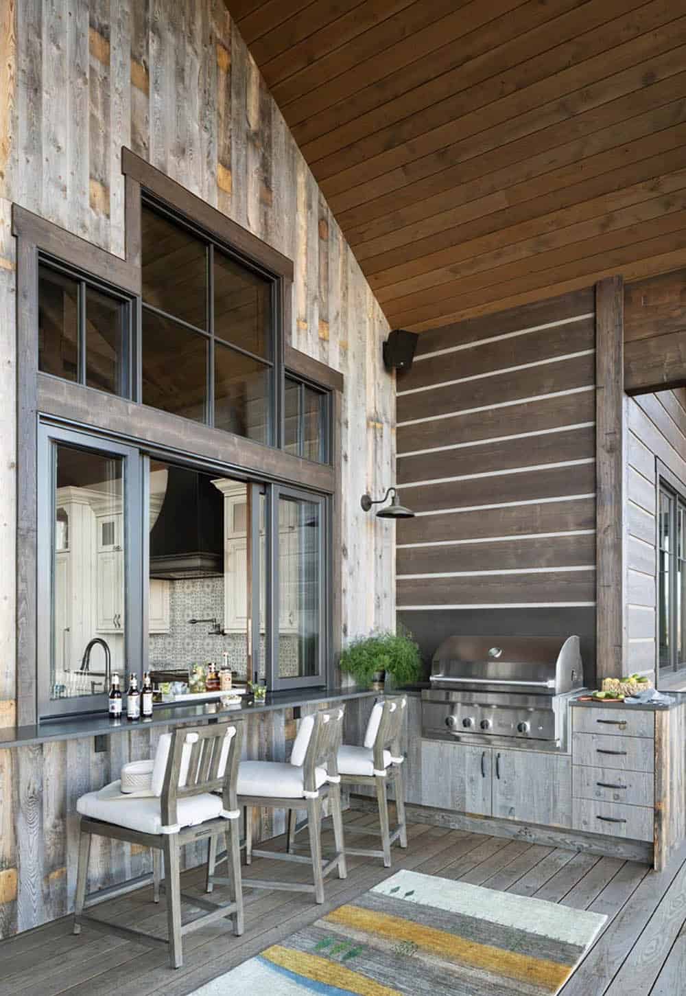 modern rustic covered patio with a pass-through window and outdoor kitchen