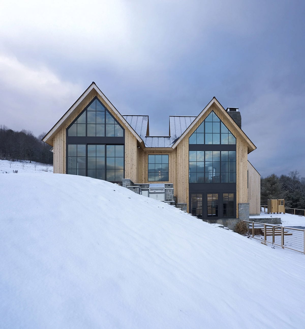 modern scandinavian home exterior with snow