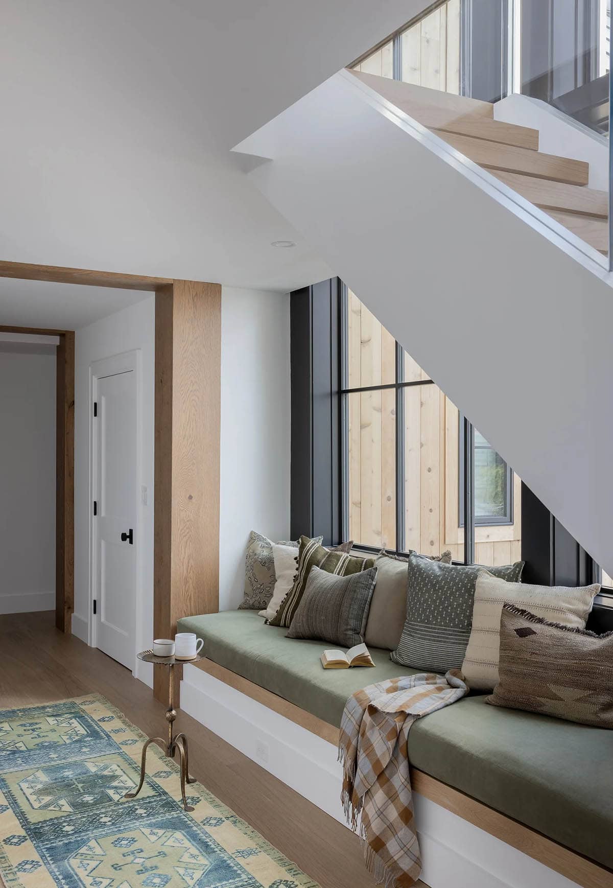 modern scandinavian style staircase with a built-in bench underneath