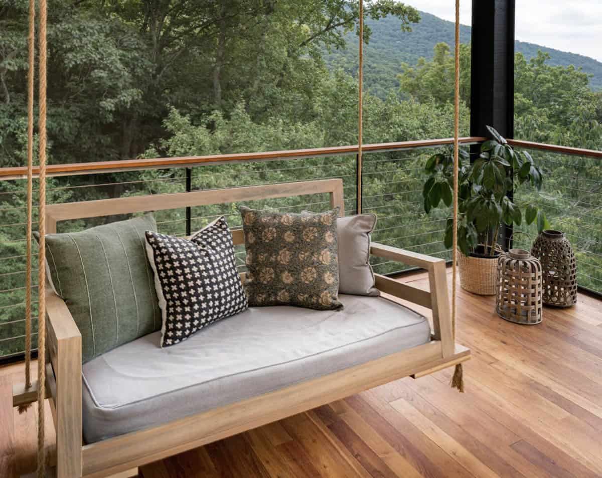 net zero house exterior deck with a hanging daybed
