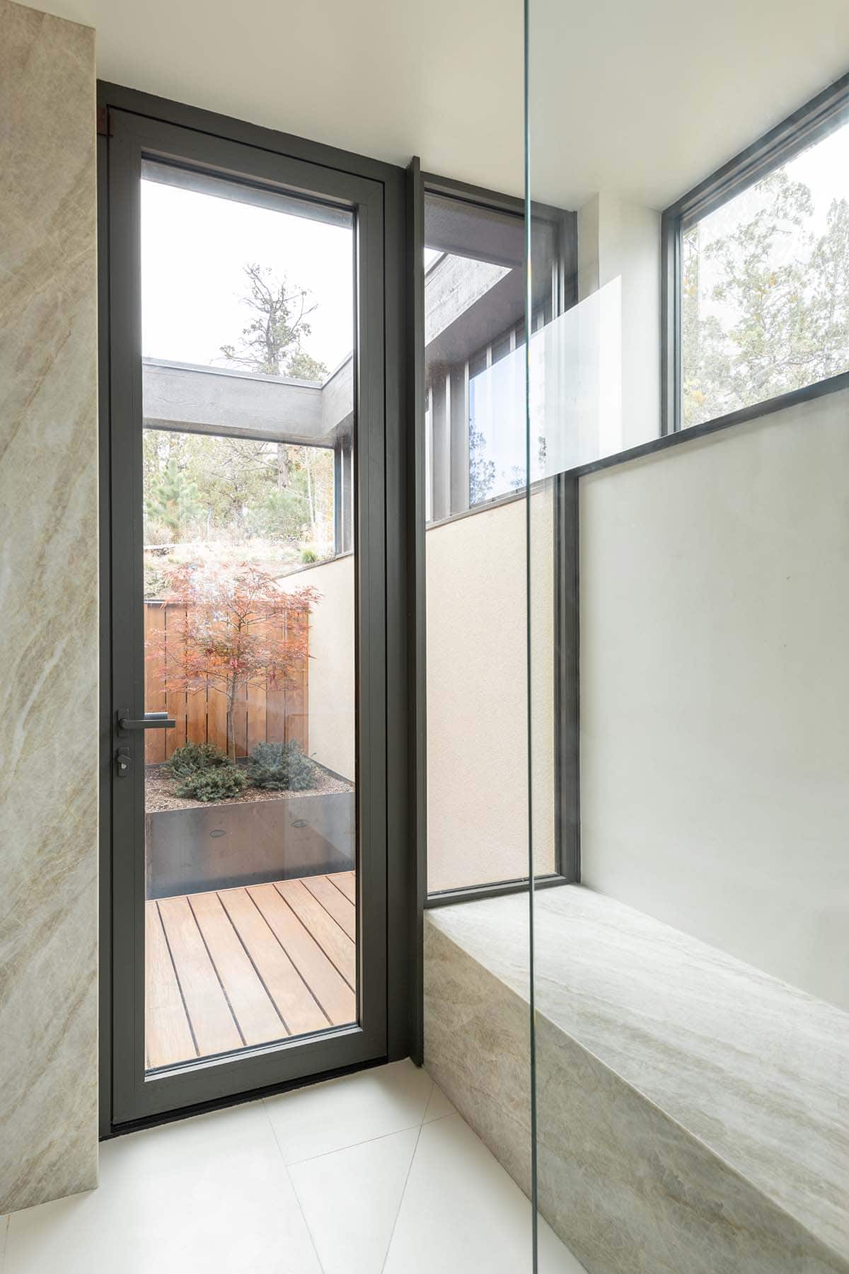 modern bathroom with a walk-in shower and built-in bench