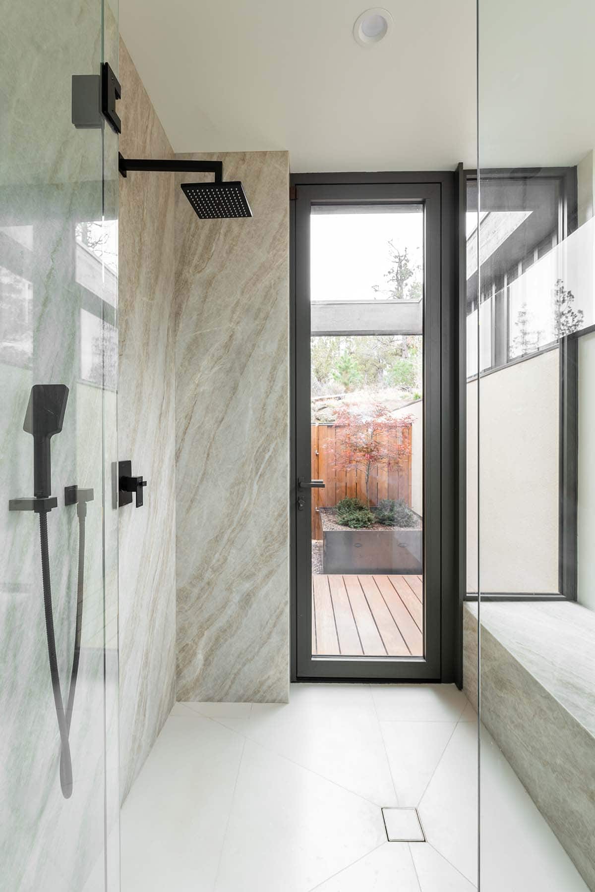 modern bathroom with a walk-in shower and built-in bench