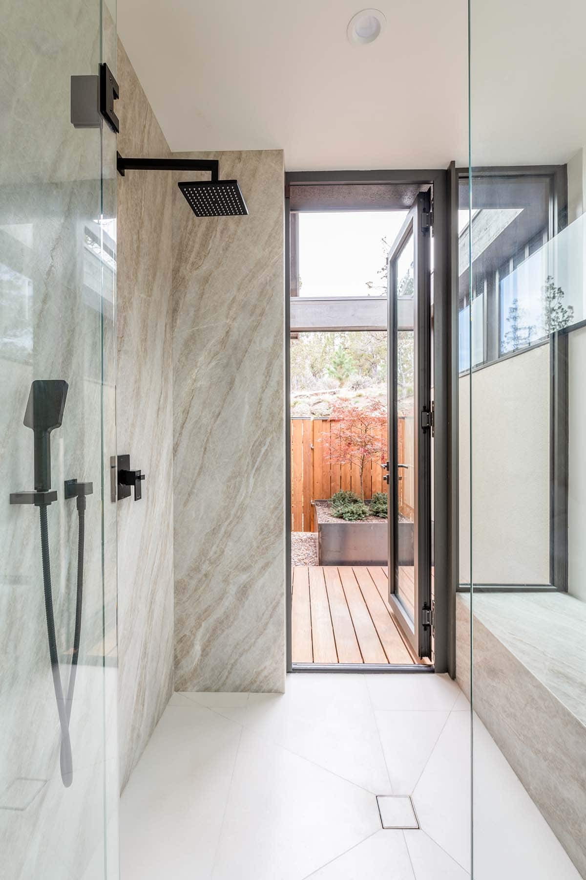 modern bathroom with a walk-in shower and built-in bench