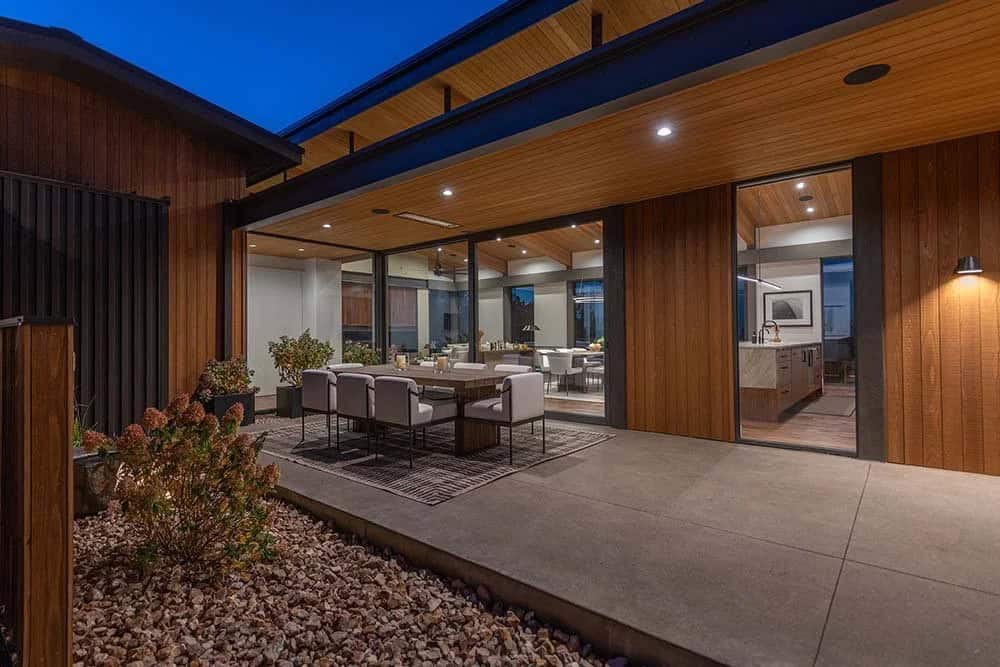 modern house exterior with a patio at dusk