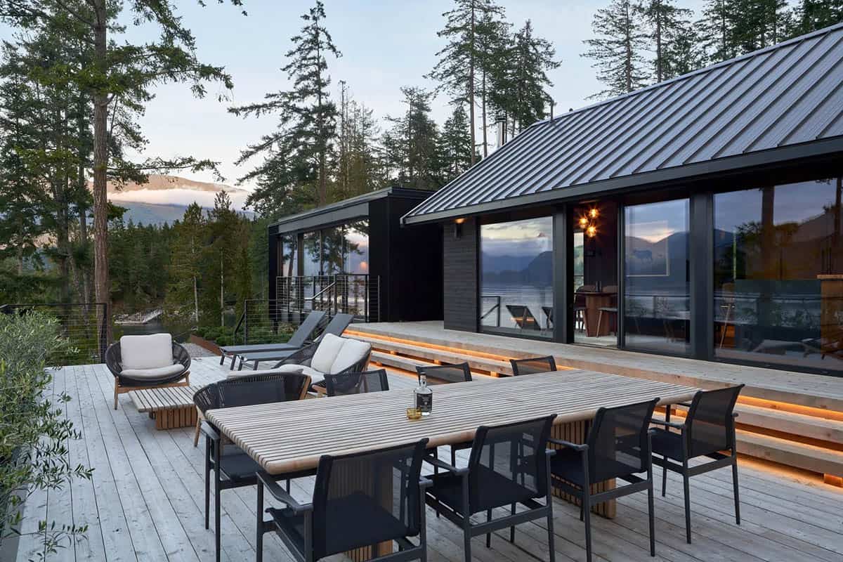 modern coastal home exterior with a backyard patio at dusk