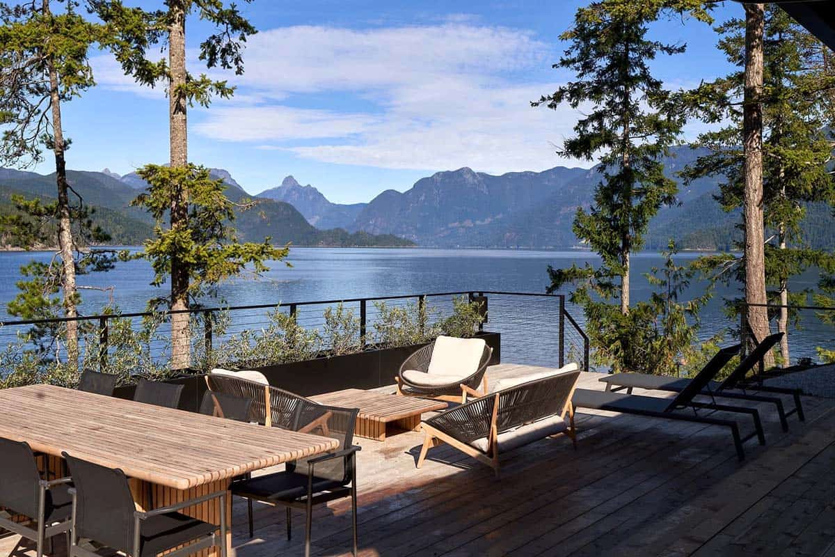 modern coastal deck with outdoor furniture overlooking the water