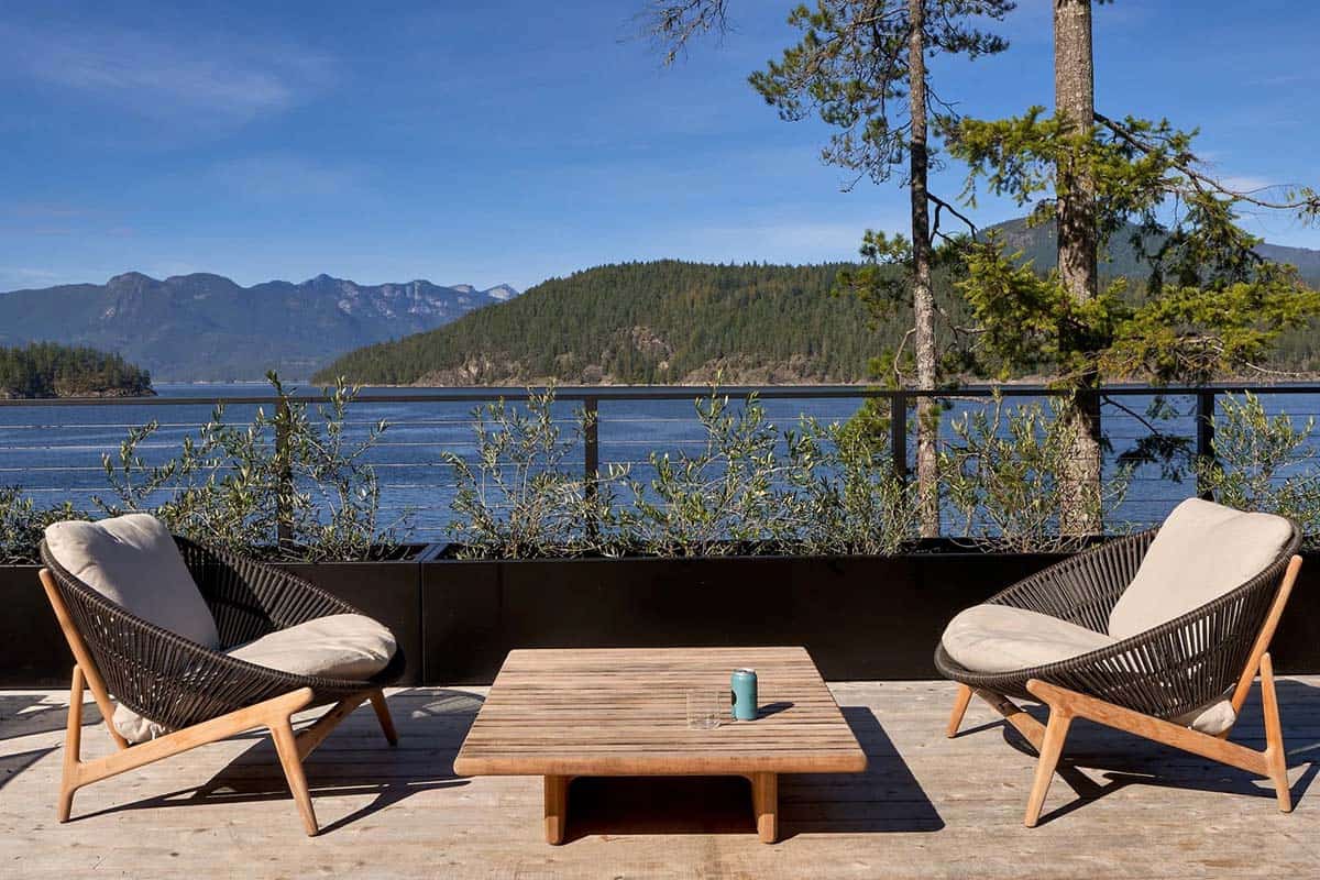 modern coastal deck with outdoor furniture overlooking the water