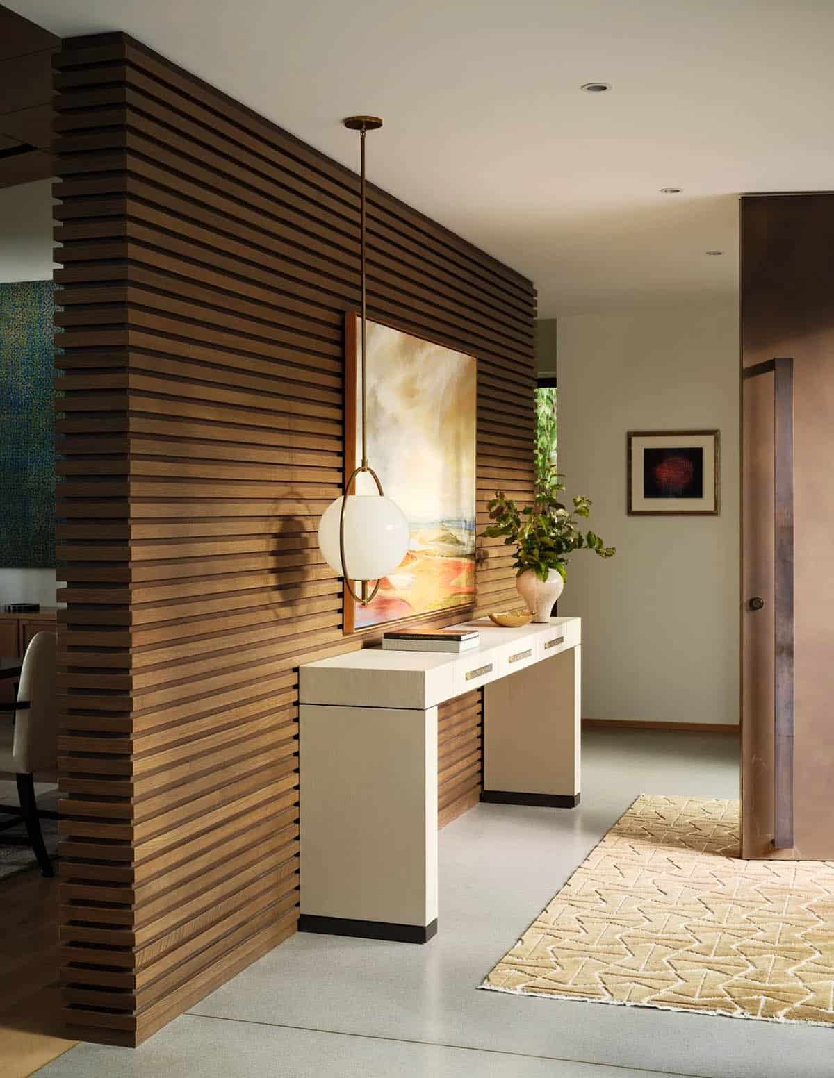 contemporary home entry with a console table