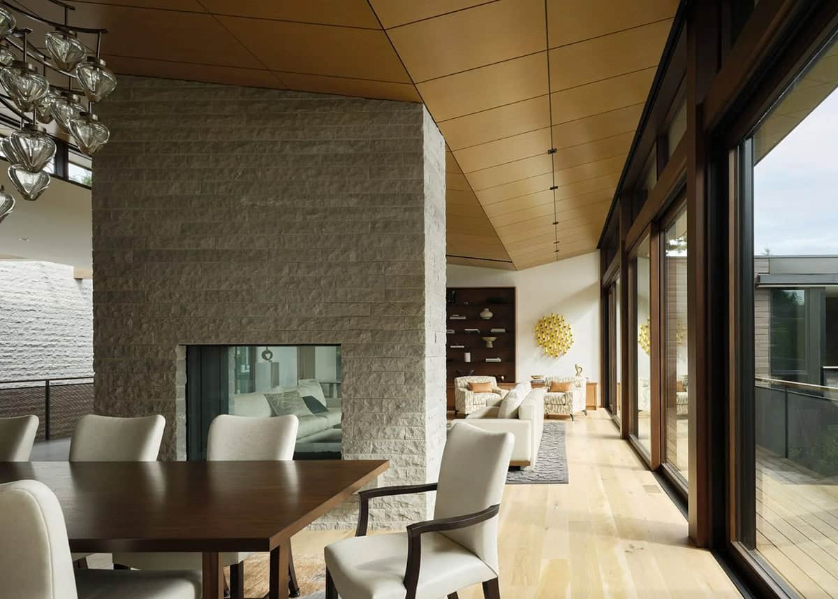 contemporary dining room with a dual sided fireplace