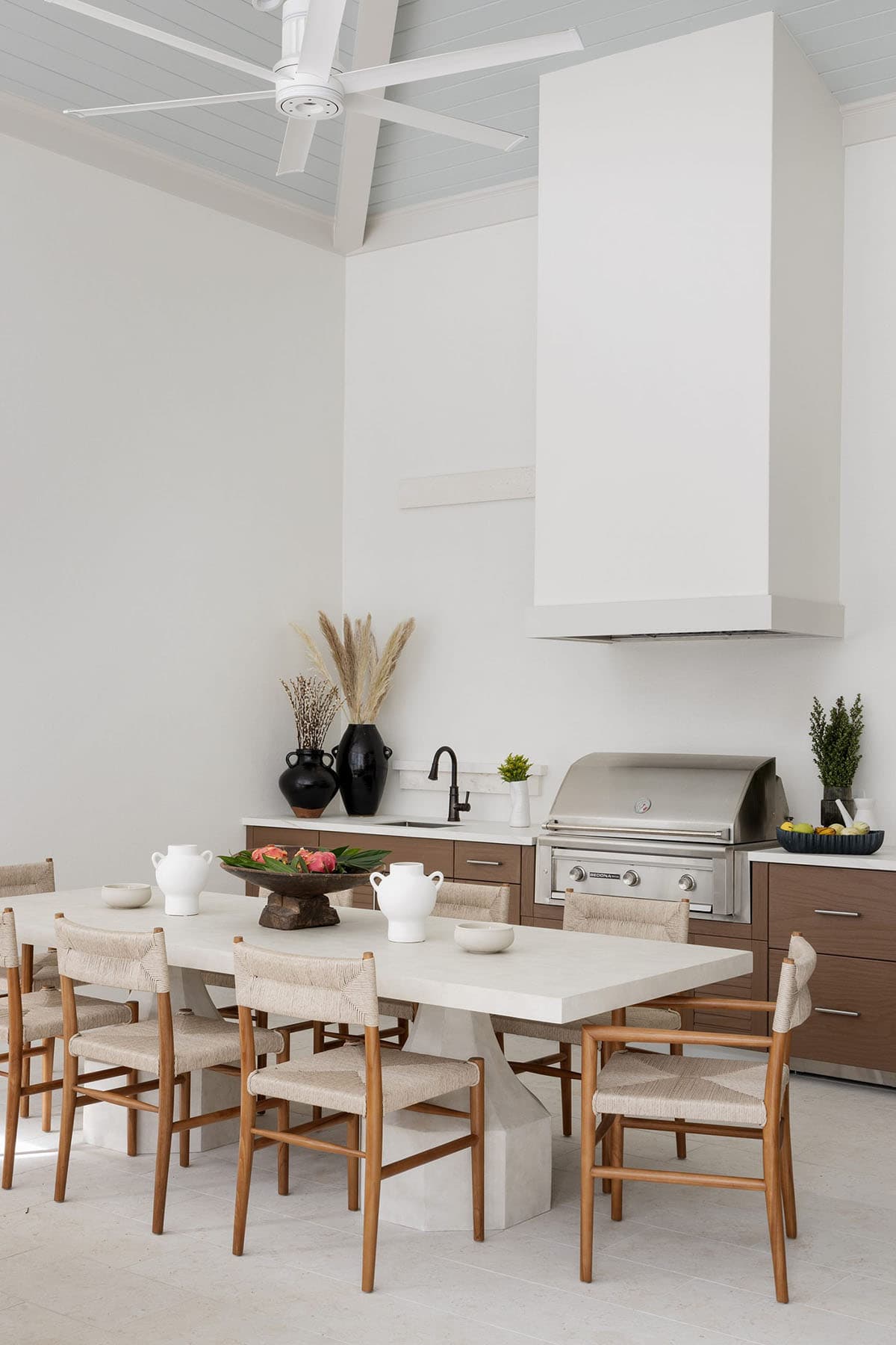 coastal style covered patio with an outdoor kitchen and grill