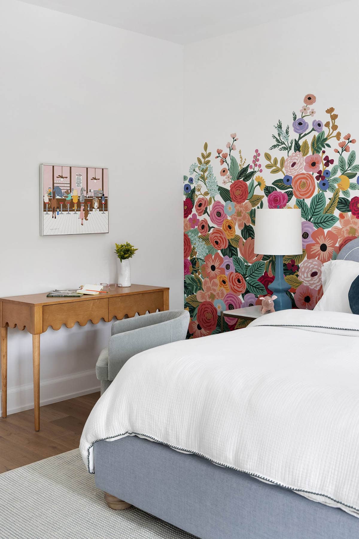 coastal style guest bedroom with a flower accent wall