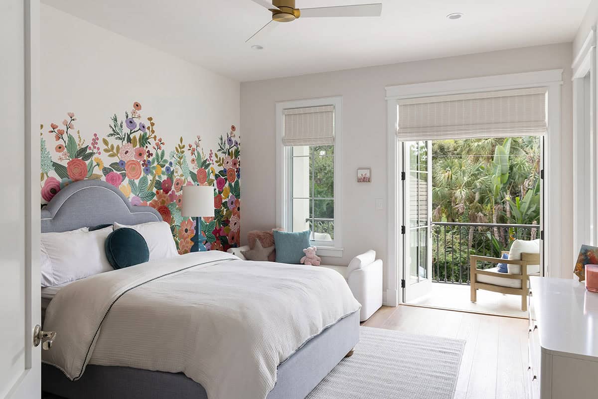 coastal style guest bedroom with a flower accent wall