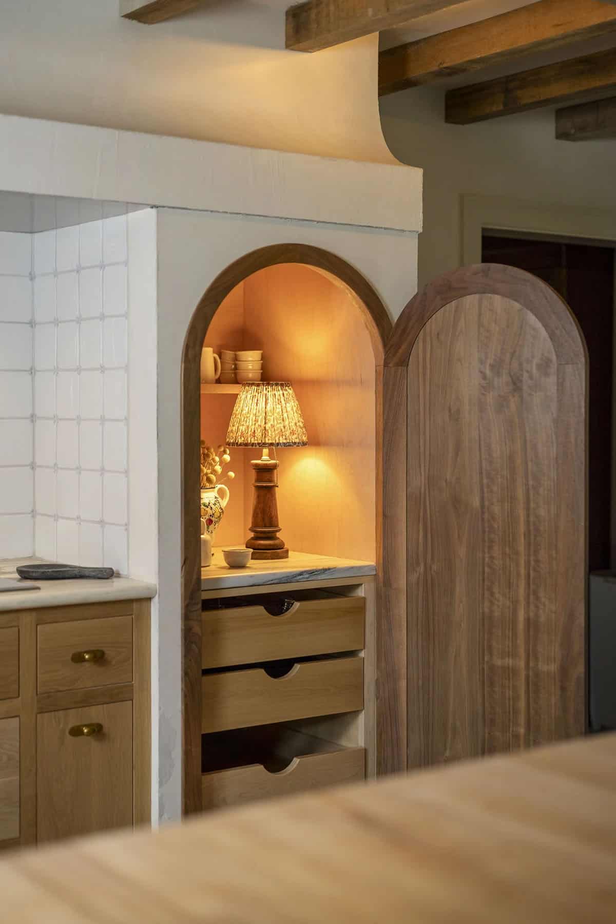 rustic kitchen with an arched door pantry