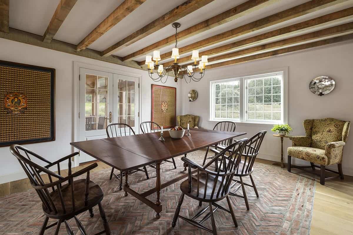 rustic dining room with wood beams on the ceiling