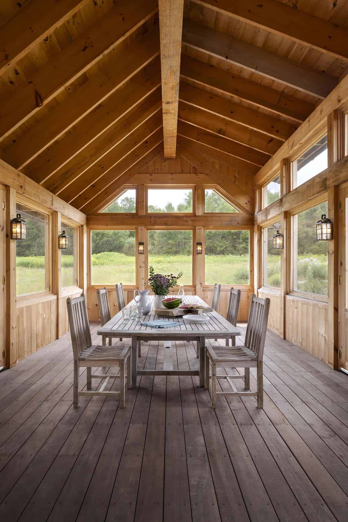 rustic screened porch with a dining room