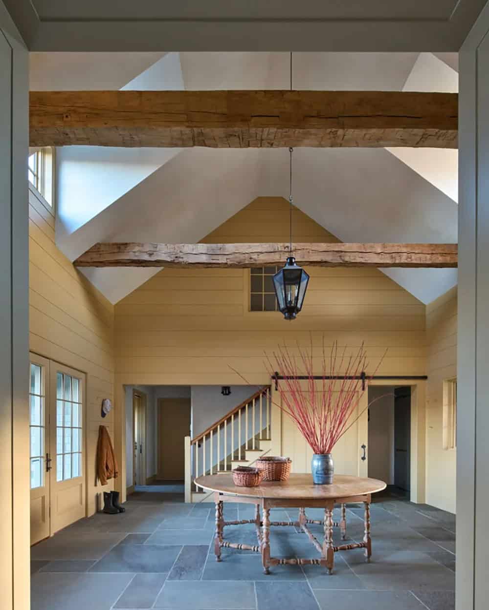 Saltbox Farm house foyer with a vaulted ceiling and exposed trusses