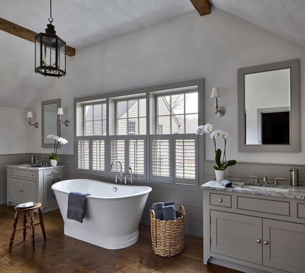 Saltbox Farm house bathroom with dual vanites and a freestanding tub