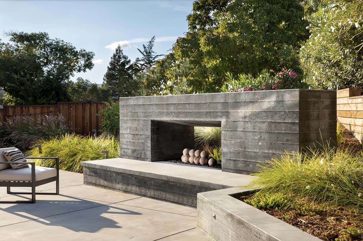 Scandinavian Modern Home Exterior patio with a board formed concrete fireplace