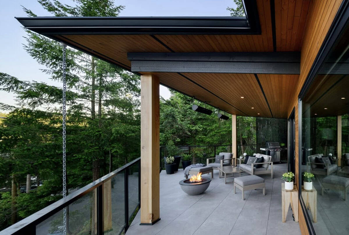 modern home exterior balcony with outdoor furniture and a fire pit