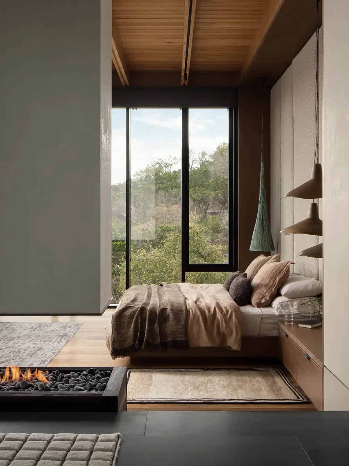modern bedroom with a dual-sided fireplace