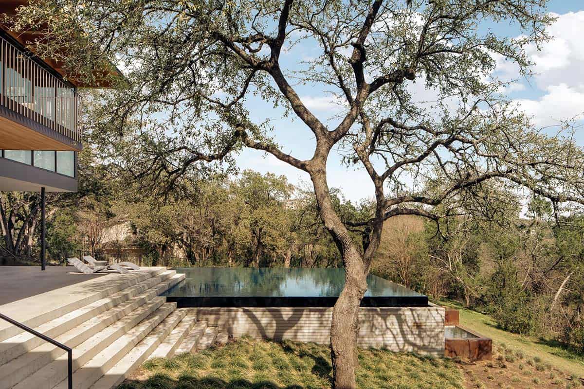 modern house exterior with pool view and a large tree