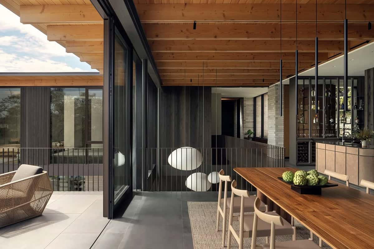 modern dining room with a sliding glass door leading to the terrace