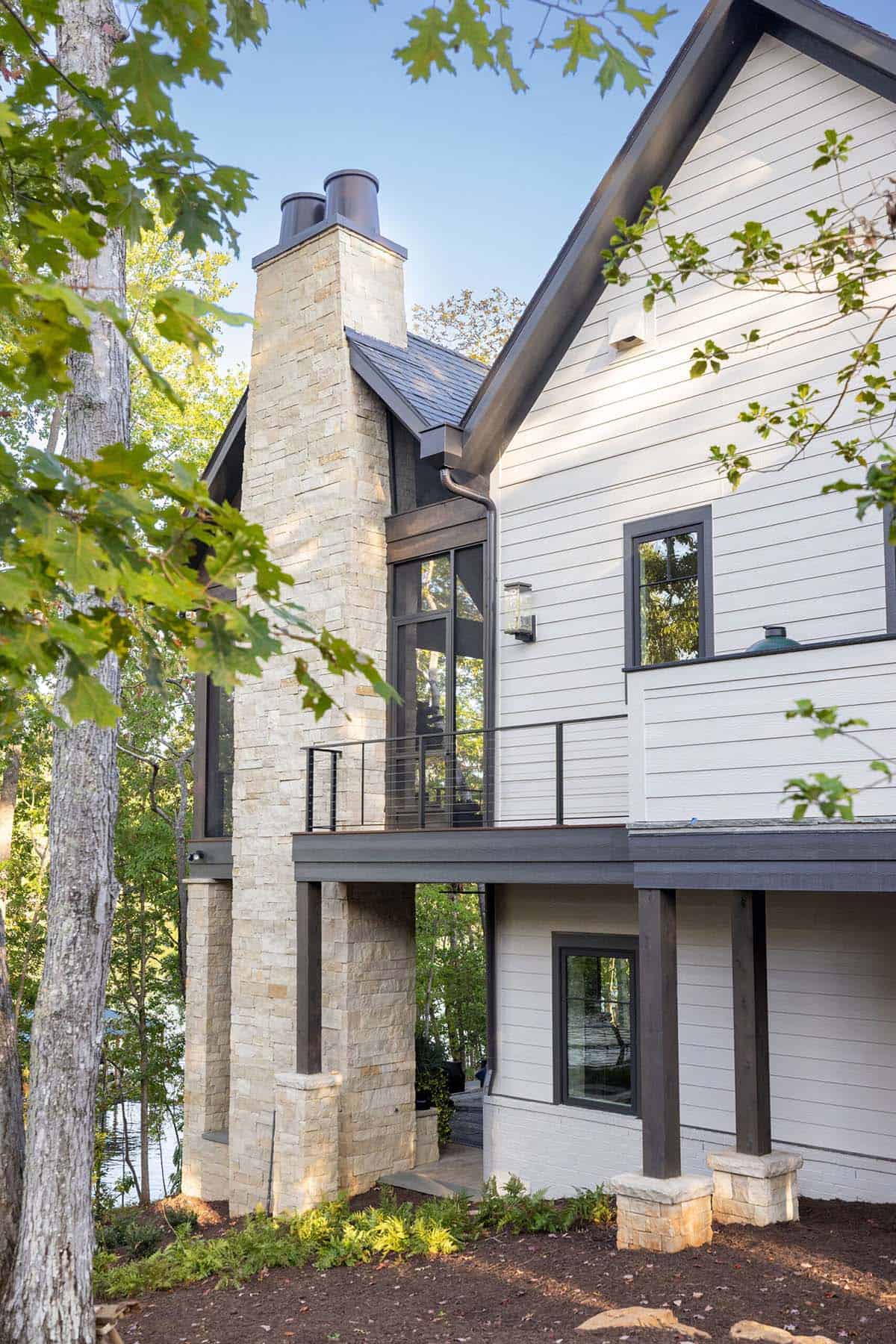 transitional style lake house exterior backyard view