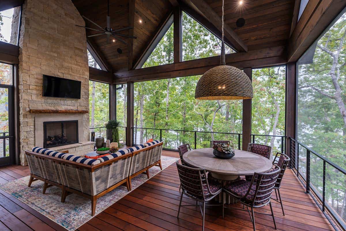 transitional style covered porch with outdoor furniture and a fireplace