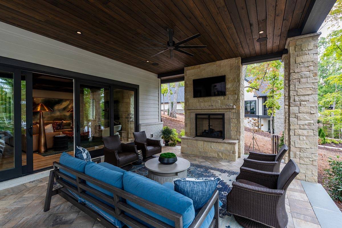 transitional style covered porch with outdoor furniture and a fireplace