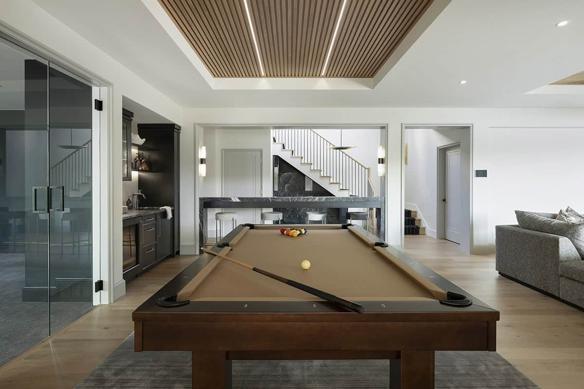 transitional style family room with a pool table 