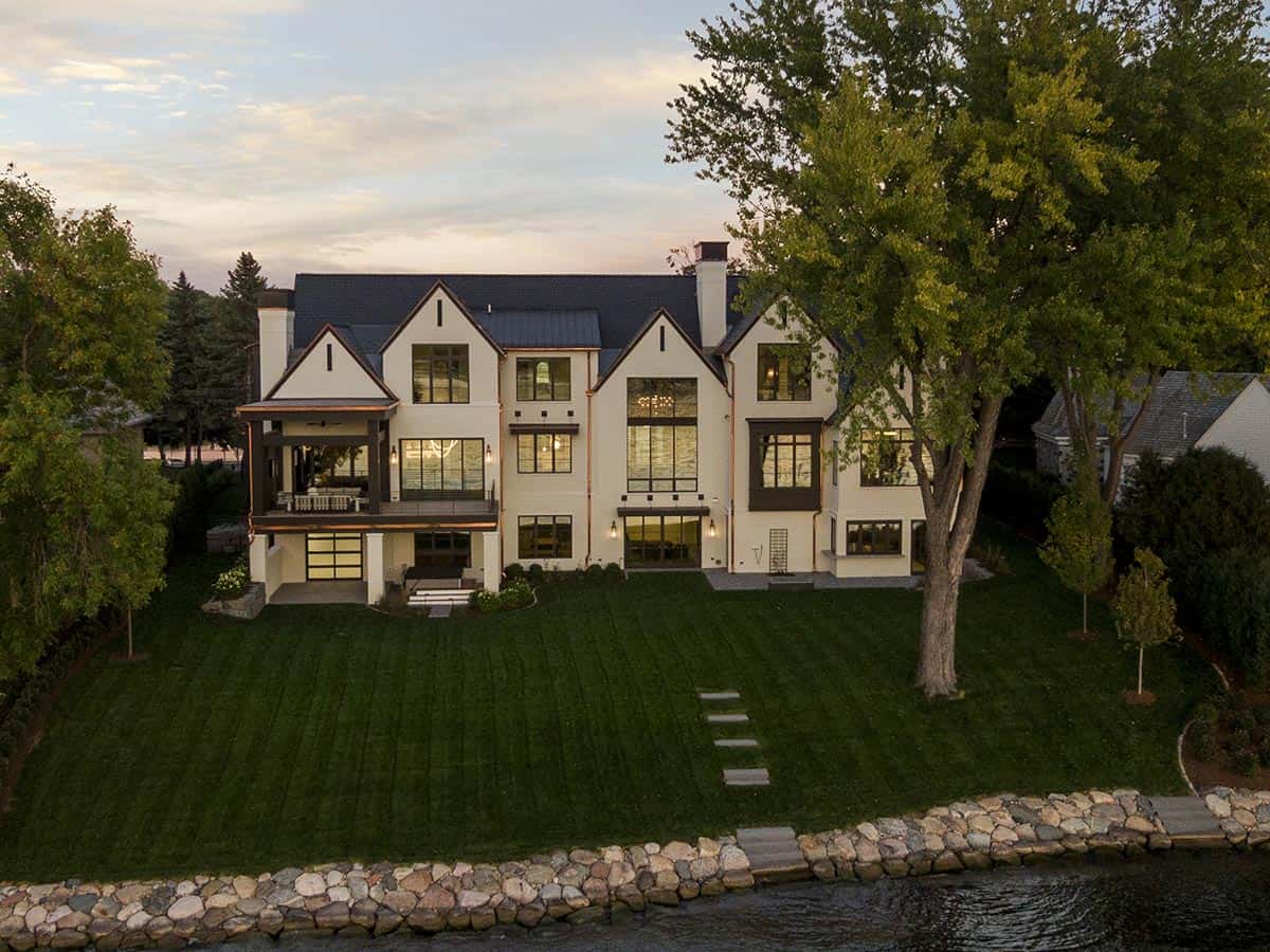 transitional style lake house exterior at dusk