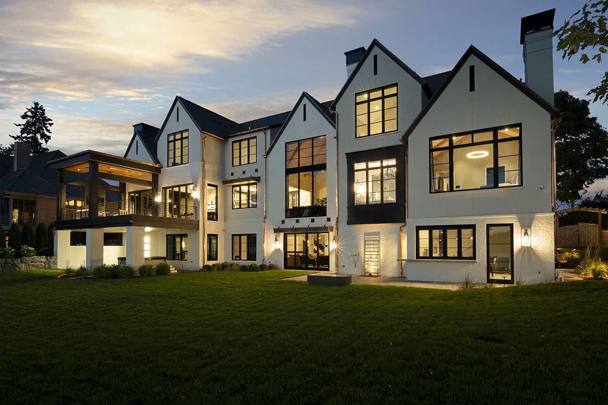 transitional style lake house exterior at dusk
