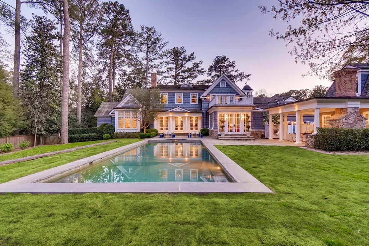 coastal style home exterior with a pool