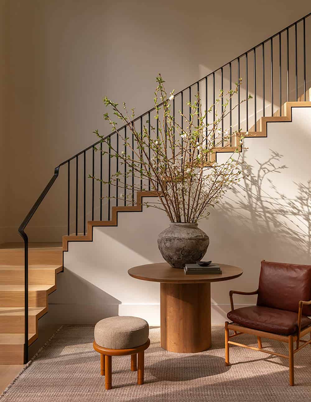 contemporary foyer with a staircase and round entry table