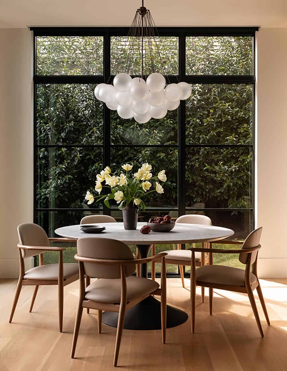 contemporary dining room with a large chandelier