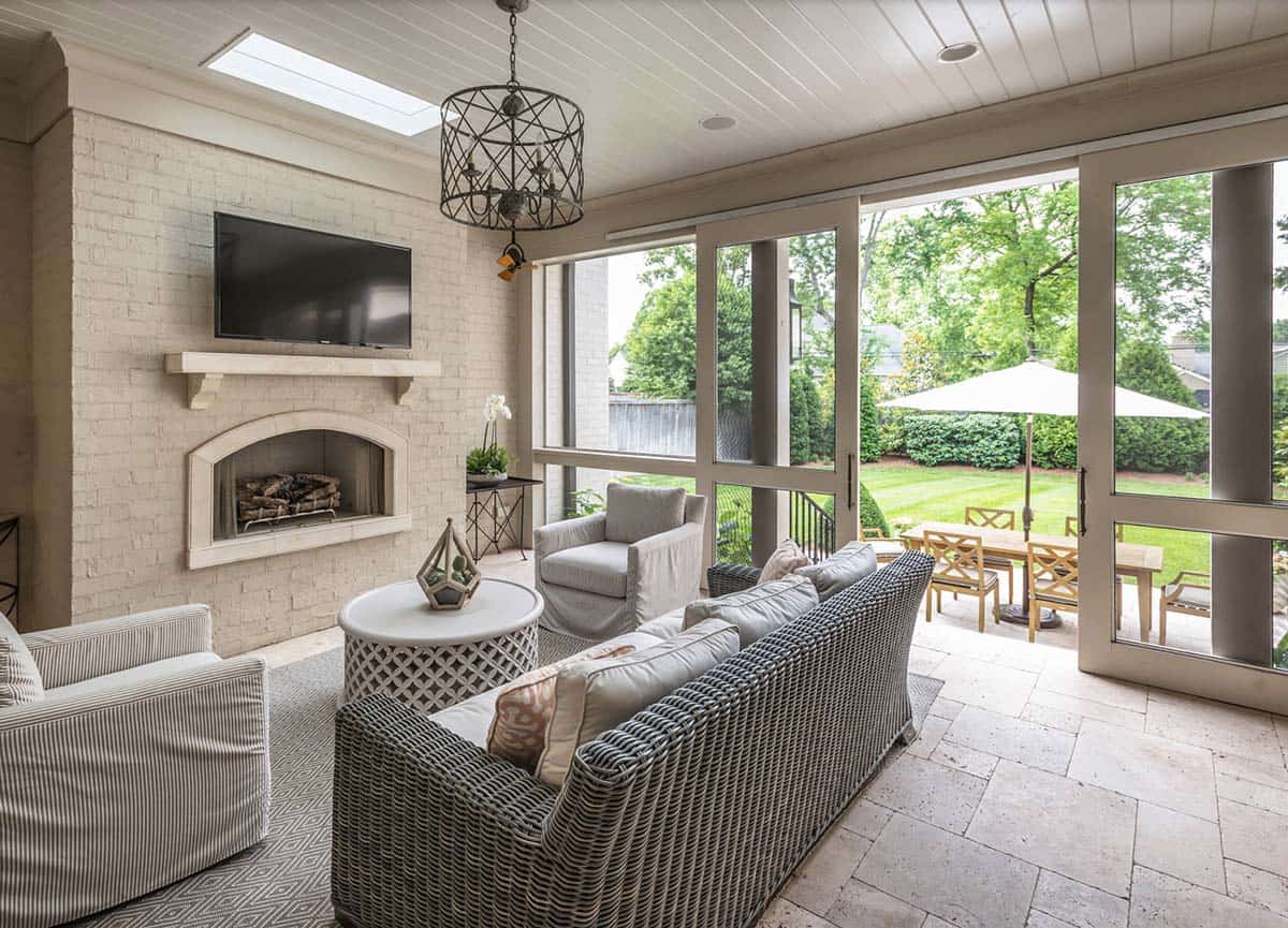 Traditional French Country sunroom with fireplace, skylight, and views of the backyard, Nashville Tennessee