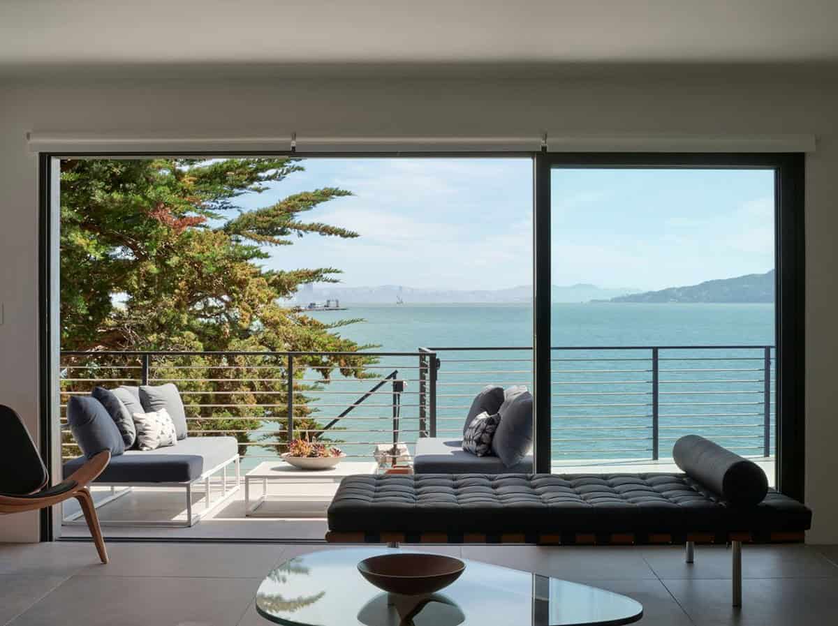 midcentury modern living room with Barcelona daybed and floor-to-ceiling sliding glass doors overlooking San Francisco Bay Point Richmond California