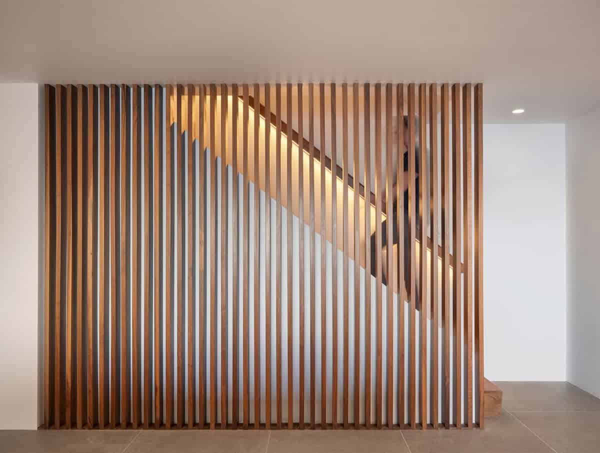 walnut slatted staircase wall with under stair LED lighting midcentury modern home renovation Point Richmond California