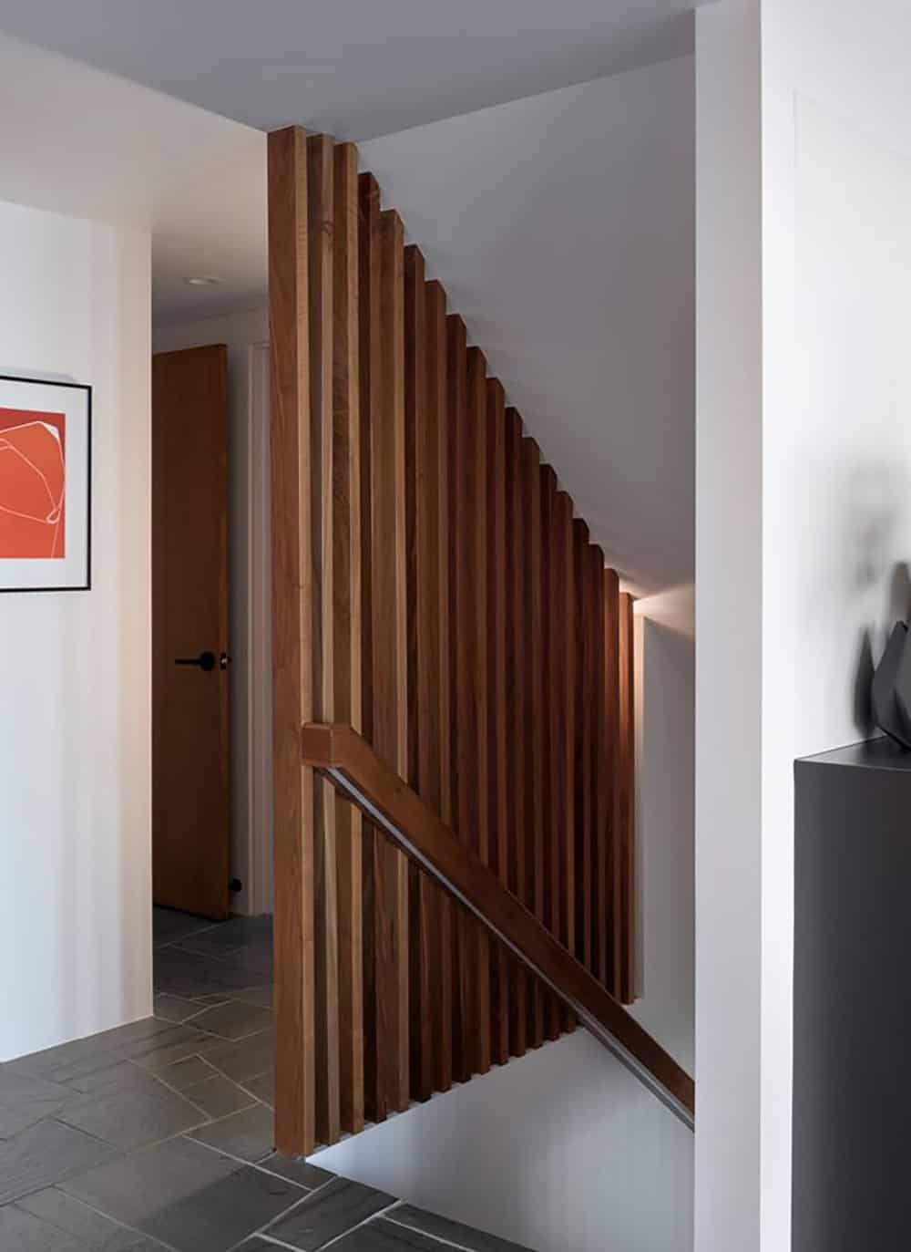 walnut slatted stair screen with walnut handrail and slate tile entry midcentury modern family home Point Richmond California