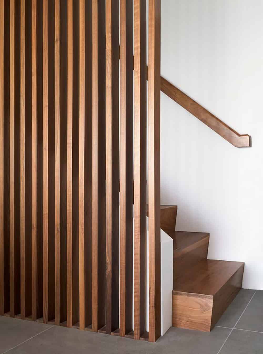 walnut slatted staircase detail with solid wood steps and handrail midcentury modern home renovation Klopf Architecture