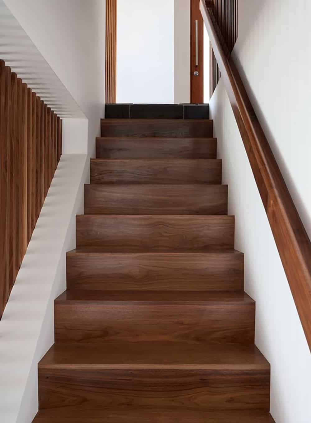 walnut stair treads with wood handrail looking up staircase midcentury modern home renovation Point Richmond California